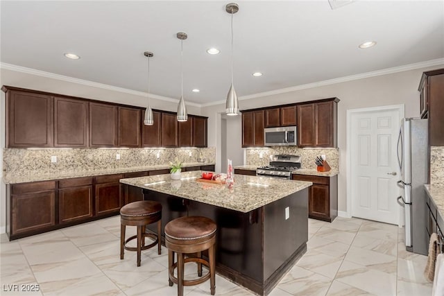 1304 Fantastic Ct, North Las Vegas, NV 89081 - kitchen with appliances with stainless steel finishes, a kitchen island, light marble finish floors, ornamental molding, and light stone countertops
