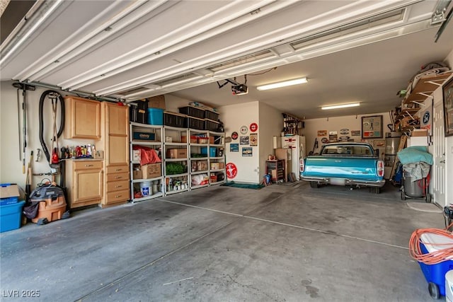 1304 Fantastic Ct, North Las Vegas, NV 89081 - garage with a garage door opener, freestanding refrigerator, and water heater