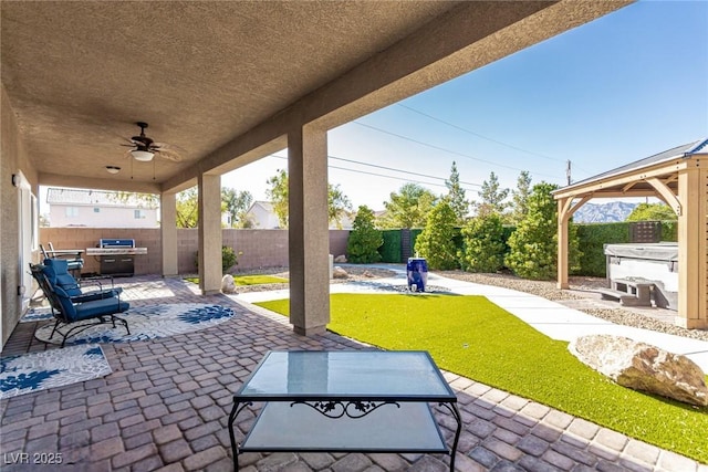 1304 Fantastic Ct, North Las Vegas, NV 89081 - fenced backyard featuring a hot tub, a patio area, and a ceiling fan