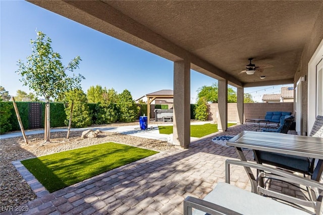 1304 Fantastic Ct, North Las Vegas, NV 89081 - fenced backyard with a ceiling fan, a patio, a gazebo, and an outdoor hangout area