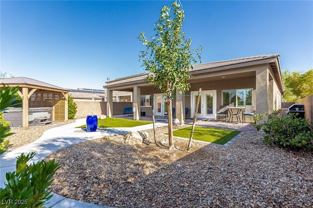 1304 Fantastic Ct, North Las Vegas, NV 89081 - back of property featuring french doors, stucco siding, and a patio