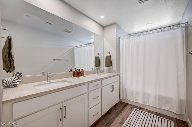 3358 Via Strada St, Henderson, NV 89044 - full bathroom featuring wood finished floors, double vanity, shower / tub combo with curtain, and recessed lighting
