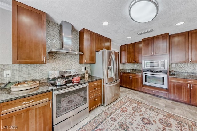 2101 Plaza Del Fuentes, Las Vegas, NV 89102 - kitchen with stainless steel appliances, wall chimney exhaust hood, a textured ceiling, tasteful backsplash, and dark stone counters