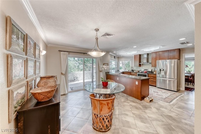 2101 Plaza Del Fuentes, Las Vegas, NV 89102 - kitchen with appliances with stainless steel finishes, wall chimney range hood, a peninsula, ornamental molding, and a textured ceiling