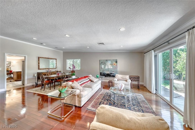 2101 Plaza Del Fuentes, Las Vegas, NV 89102 - living room featuring crown molding, wood finished floors, a textured ceiling, and recessed lighting