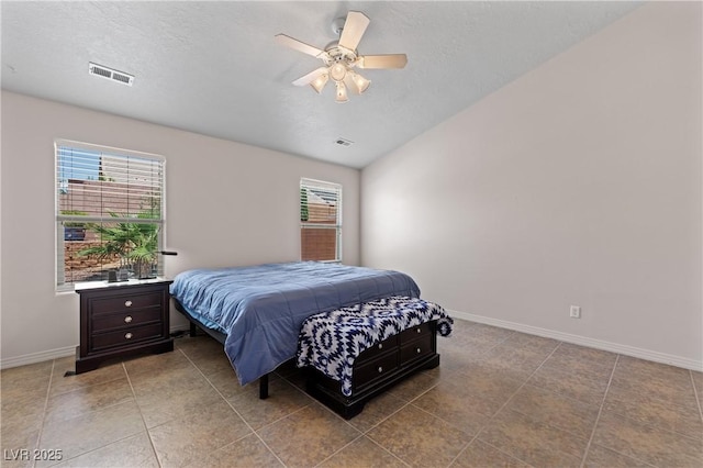 871 Falcon Glenn Dr, Mesquite, NV 89027 - bedroom with multiple windows, vaulted ceiling, tile patterned floors, and ceiling fan