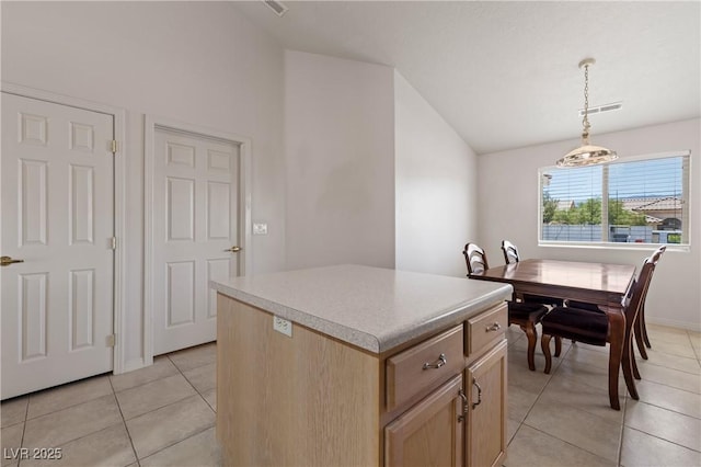 871 Falcon Glenn Dr, Mesquite, NV 89027 - kitchen featuring vaulted ceiling, a center island, light tile patterned floors, light brown cabinetry, and decorative light fixtures