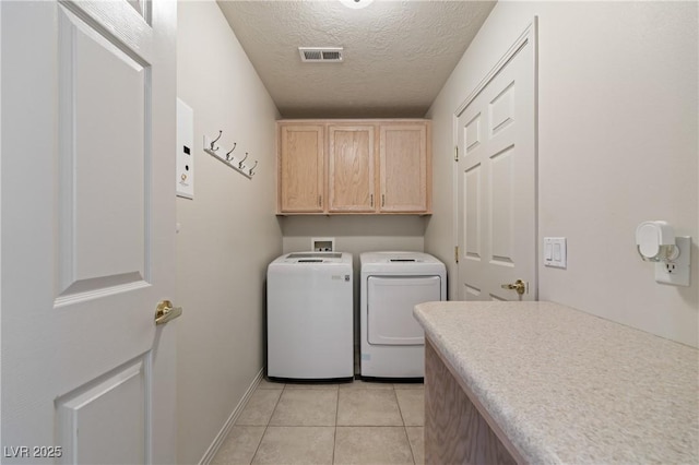 871 Falcon Glenn Dr, Mesquite, NV 89027 - laundry area featuring cabinet space, washing machine and dryer, a textured ceiling, and light tile patterned floors