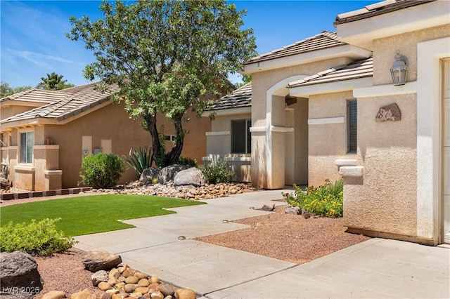 871 Falcon Glenn Dr, Mesquite, NV 89027 - doorway to property with stucco siding, a tiled roof, and a yard