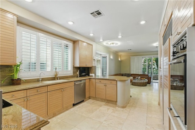 8215 Crow Valley Ln, Las Vegas, NV 89113 - kitchen featuring stainless steel appliances, a peninsula, backsplash, recessed lighting, and open floor plan