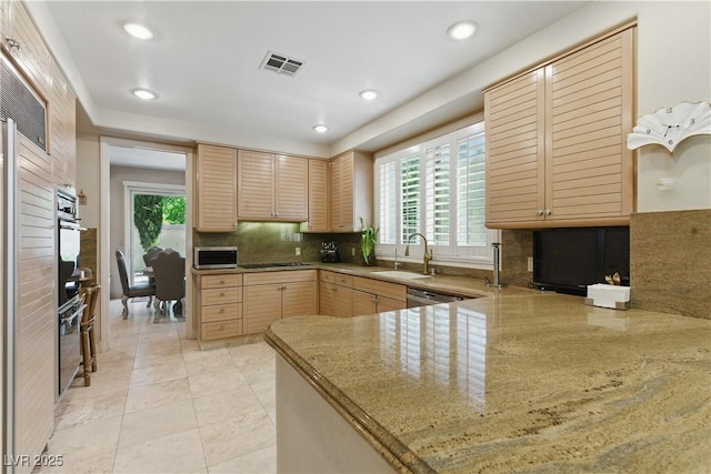 8215 Crow Valley Ln, Las Vegas, NV 89113 - kitchen featuring light brown cabinets, tasteful backsplash, plenty of natural light, recessed lighting, and a peninsula