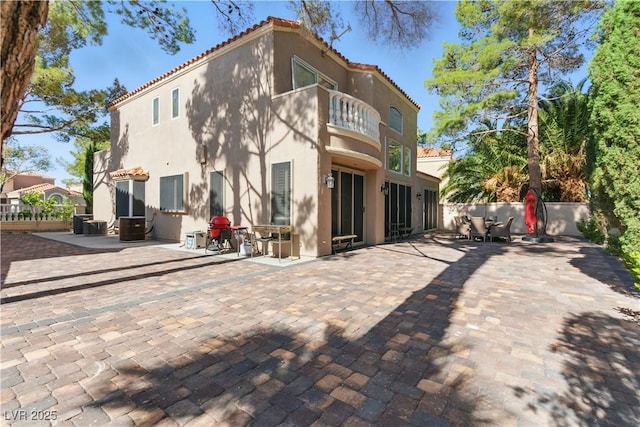 8215 Crow Valley Ln, Las Vegas, NV 89113 - back of property featuring a balcony, a tile roof, stucco siding, and a patio