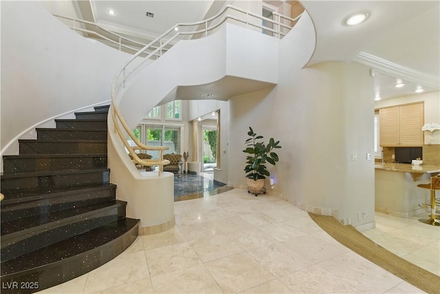 8215 Crow Valley Ln, Las Vegas, NV 89113 - stairway featuring a high ceiling and recessed lighting