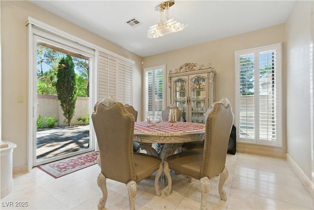 8215 Crow Valley Ln, Las Vegas, NV 89113 - dining area with healthy amount of natural light and light tile patterned floors