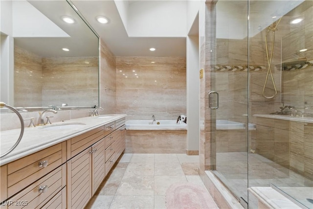 8215 Crow Valley Ln, Las Vegas, NV 89113 - bathroom with a garden tub, double vanity, a stall shower, recessed lighting, and tile walls