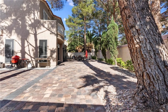 8215 Crow Valley Ln, Las Vegas, NV 89113 - view of property exterior featuring stucco siding, a balcony, and a patio area