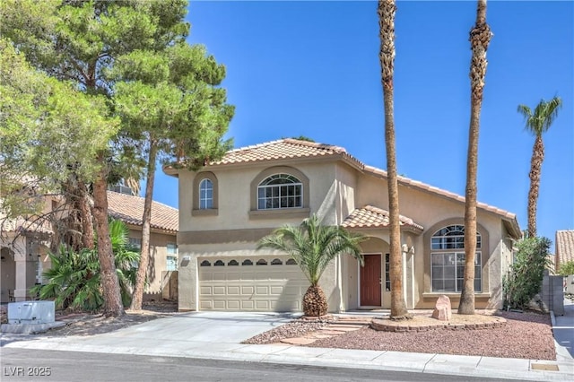 8712 Texas Bronco Ave, Las Vegas, NV 89129 - mediterranean / spanish-style home with a tiled roof, stucco siding, concrete driveway, and a garage
