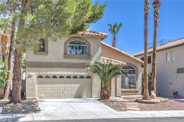 8712 Texas Bronco Ave, Las Vegas, NV 89129 - mediterranean / spanish-style house featuring stucco siding, a tile roof, driveway, and an attached garage