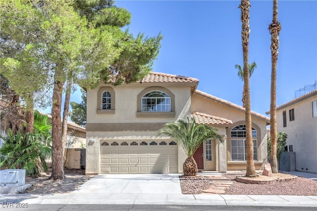 8712 Texas Bronco Ave, Las Vegas, NV 89129 - mediterranean / spanish-style home with stucco siding, a tile roof, concrete driveway, and an attached garage