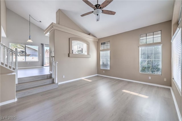 8712 Texas Bronco Ave, Las Vegas, NV 89129 - unfurnished room featuring high vaulted ceiling, stairs, wood finished floors, and ceiling fan