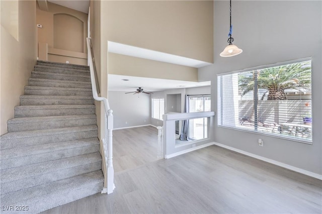 8712 Texas Bronco Ave, Las Vegas, NV 89129 - stairway with wood finished floors, a high ceiling, and ceiling fan