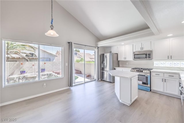 8712 Texas Bronco Ave, Las Vegas, NV 89129 - kitchen with stainless steel appliances, light wood finished floors, white cabinets, high vaulted ceiling, and a kitchen island