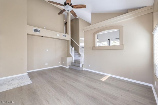 8712 Texas Bronco Ave, Las Vegas, NV 89129 - unfurnished living room with a ceiling fan, wood finished floors, stairway, and lofted ceiling
