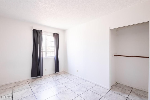 5673 Coaldale Pl, Las Vegas, NV 89110 - unfurnished bedroom featuring a textured ceiling and light tile patterned flooring