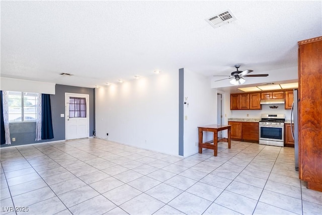 5673 Coaldale Pl, Las Vegas, NV 89110 - unfurnished living room featuring light tile patterned flooring, ceiling fan, and a textured ceiling