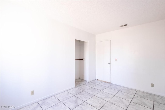 5673 Coaldale Pl, Las Vegas, NV 89110 - unfurnished room with light tile patterned floors and a textured ceiling
