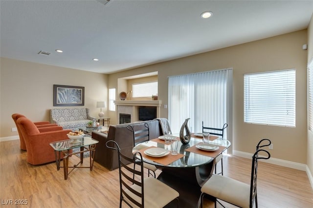 10243 Songsparrow Ct, Las Vegas, NV 89135 - dining space with light wood-style flooring, a fireplace, and recessed lighting