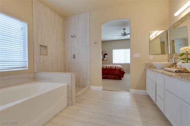 10243 Songsparrow Ct, Las Vegas, NV 89135 - bathroom with double vanity, a garden tub, ceiling fan, a walk in shower, and ensuite bath