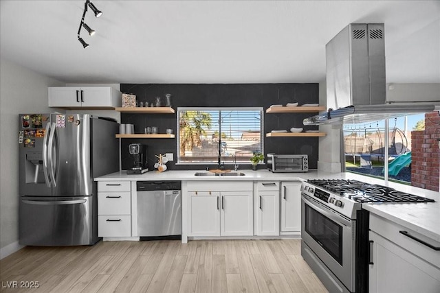 2088 Miner Way, Las Vegas, NV 89104 - kitchen featuring appliances with stainless steel finishes, open shelves, island exhaust hood, and plenty of natural light
