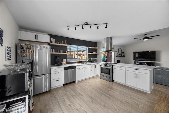 2088 Miner Way, Las Vegas, NV 89104 - kitchen featuring stainless steel appliances, wall chimney exhaust hood, open shelves, a peninsula, and open floor plan