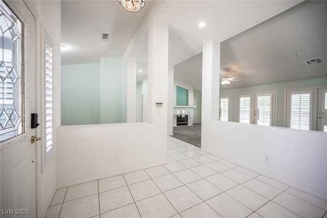 9728 Drumcannon Ave, Las Vegas, NV 89129 - entryway featuring light colored carpet, light tile patterned flooring, a glass covered fireplace, a ceiling fan, and recessed lighting