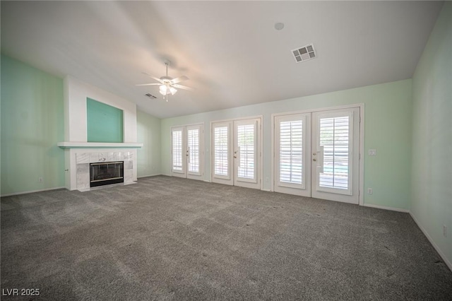 9728 Drumcannon Ave, Las Vegas, NV 89129 - unfurnished living room featuring ceiling fan, a premium fireplace, carpet flooring, lofted ceiling, and french doors