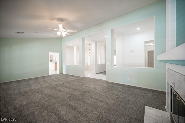 9728 Drumcannon Ave, Las Vegas, NV 89129 - unfurnished living room featuring carpet floors, ceiling fan, a tile fireplace, and recessed lighting