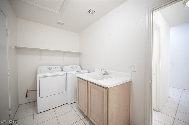 9728 Drumcannon Ave, Las Vegas, NV 89129 - laundry area featuring cabinet space, independent washer and dryer, and light tile patterned flooring