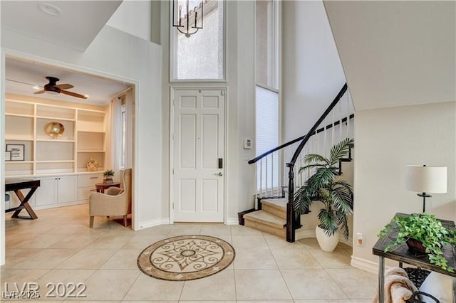 3111 Lido Isle Ct, Las Vegas, NV 89117 - entryway with a high ceiling, plenty of natural light, light tile patterned floors, stairway, and ceiling fan