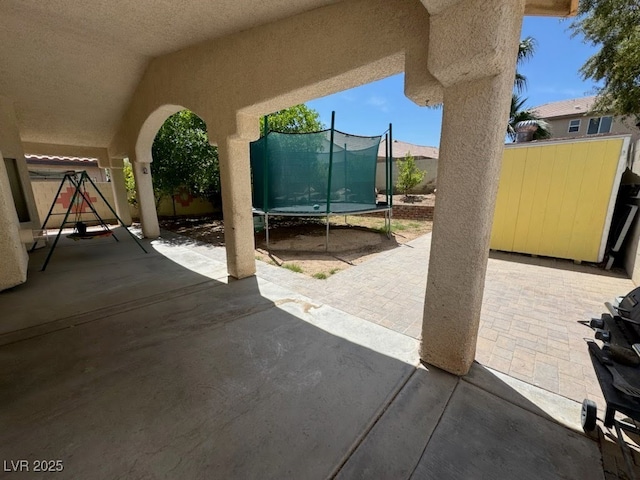 8277 Orange Vale Ave, Las Vegas, NV 89131 - fenced backyard featuring a trampoline and a patio