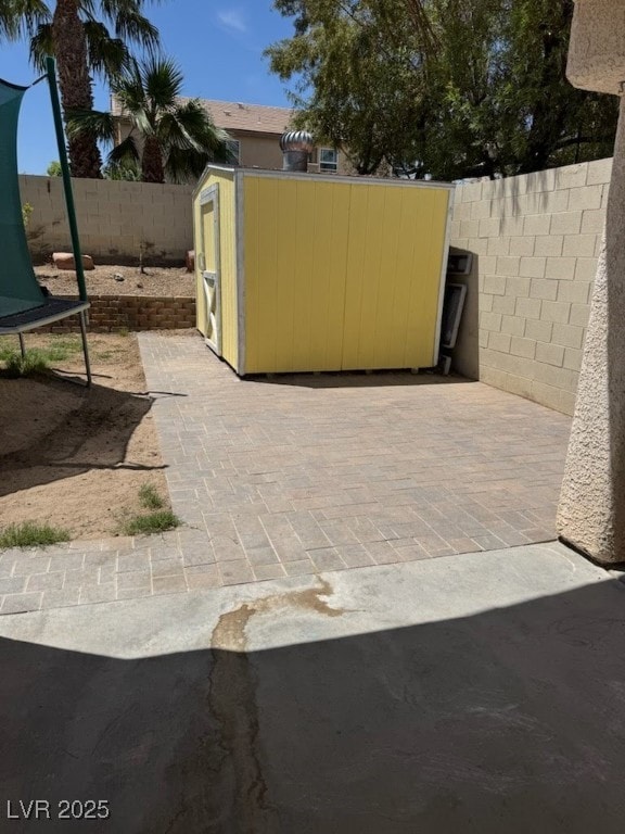 8277 Orange Vale Ave, Las Vegas, NV 89131 - fenced backyard with a storage unit and a patio