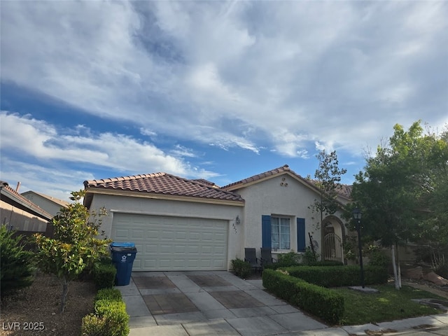 8277 Orange Vale Ave, Las Vegas, NV 89131 - mediterranean / spanish-style home with driveway, an attached garage, stucco siding, and a tile roof