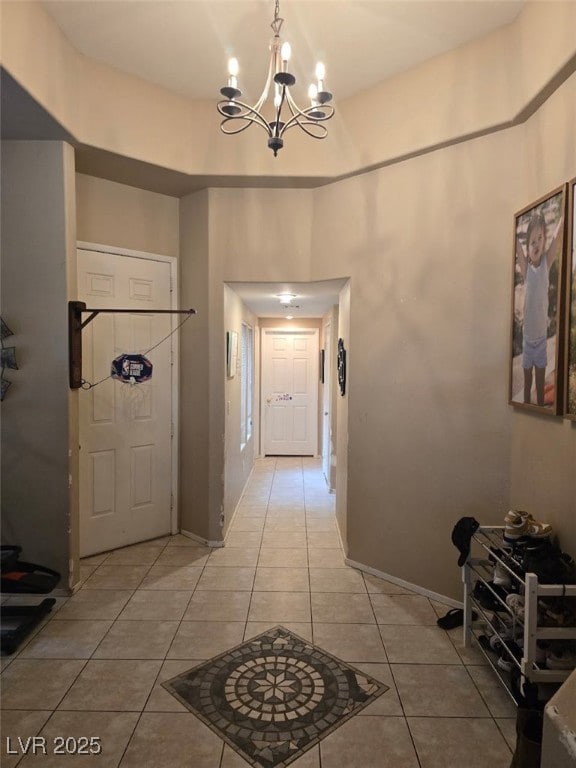 8277 Orange Vale Ave, Las Vegas, NV 89131 - hallway with light tile patterned floors and a chandelier