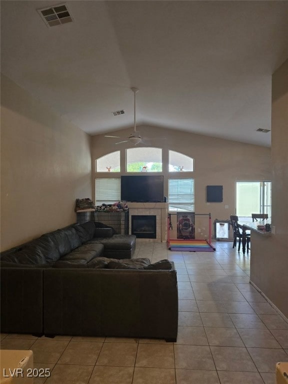 8277 Orange Vale Ave, Las Vegas, NV 89131 - living area featuring lofted ceiling, light tile patterned floors, ceiling fan, and a tile fireplace