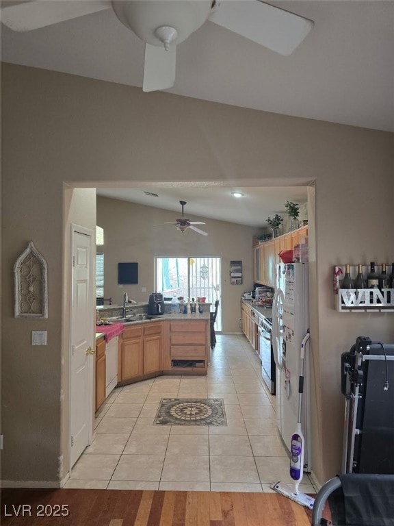 8277 Orange Vale Ave, Las Vegas, NV 89131 - kitchen with a peninsula, light tile patterned floors, ceiling fan, light countertops, and white appliances