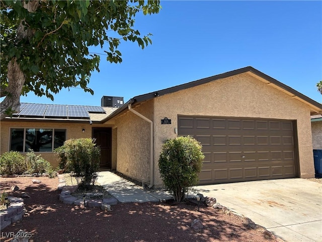 608 Watkins Dr, Las Vegas, NV 89107 - ranch-style house featuring an attached garage, stucco siding, roof mounted solar panels, and driveway