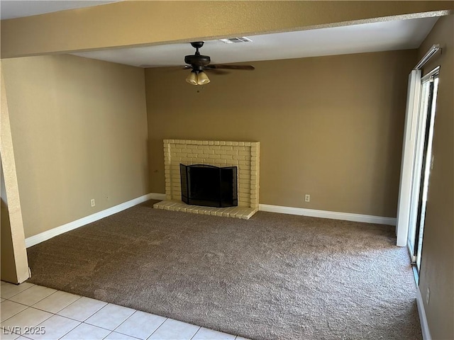 608 Watkins Dr, Las Vegas, NV 89107 - unfurnished living room with light carpet, a ceiling fan, and a brick fireplace