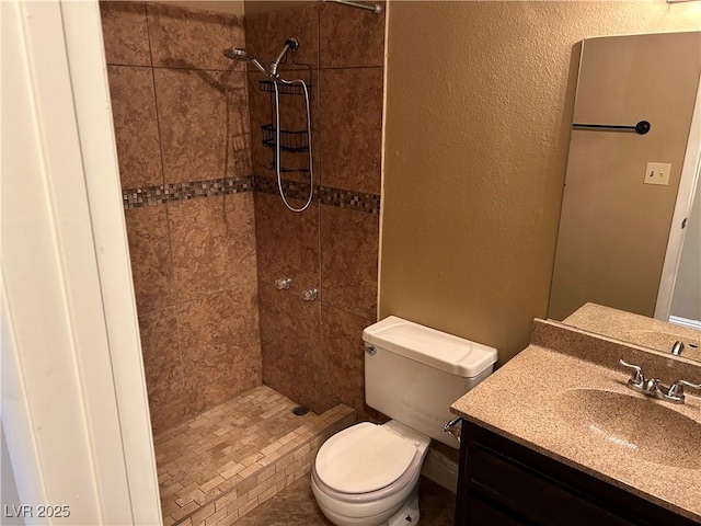 608 Watkins Dr, Las Vegas, NV 89107 - bathroom featuring tiled shower, vanity, and a textured wall