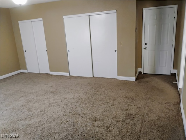 608 Watkins Dr, Las Vegas, NV 89107 - unfurnished bedroom featuring two closets and carpet flooring