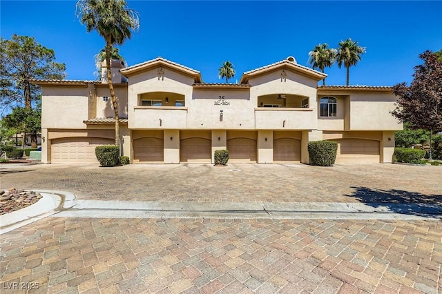 2050 W Warm Springs Rd Unit 3624, Henderson, NV 89014 - view of front of property with an attached garage, stucco siding, driveway, a balcony, and a tiled roof